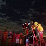 In this photo taken Friday, Feb. 3, 2017, a student looks up at the moon through a telescope, during a visit by The Traveling Telescope to show students the science of astronomy, at St Andrew's School near Molo in Kenya's Rift Valley. Although Kenya lies on the equator and has dramatic nighttime skies in rural areas, children find it hard to name planets and other bodies as astronomy is rarely taught in schools - but that is changing as The Traveling Telescope visits some of the country's most remote areas with telescopes and virtual reality goggles. (AP Photo/Ben Curtis)